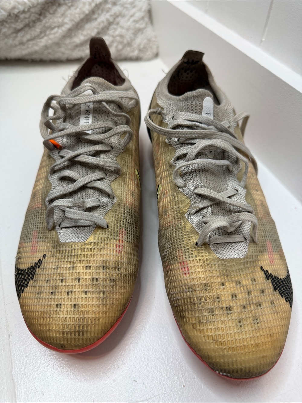 Nike Men's Beige Knit Athletic Sneakers with Black Swoosh and Red Accents